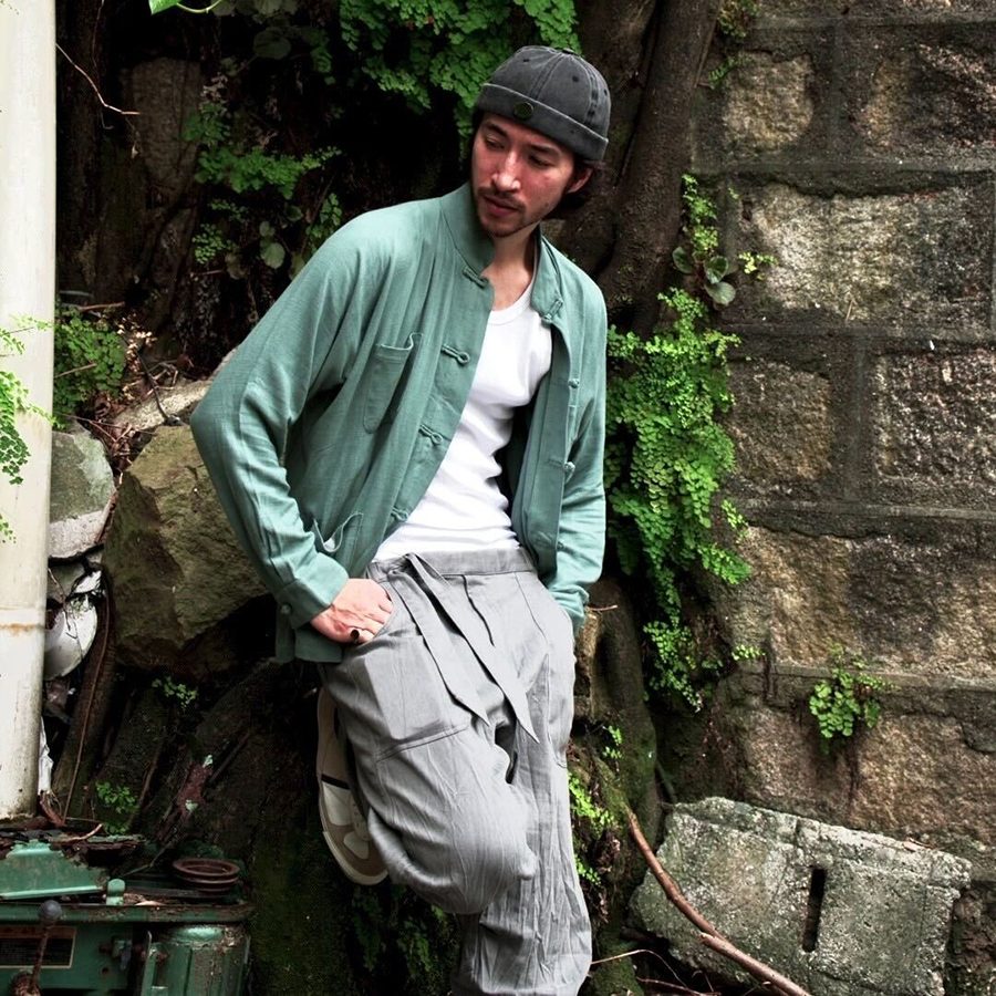 Model wearing green jacket from GOD